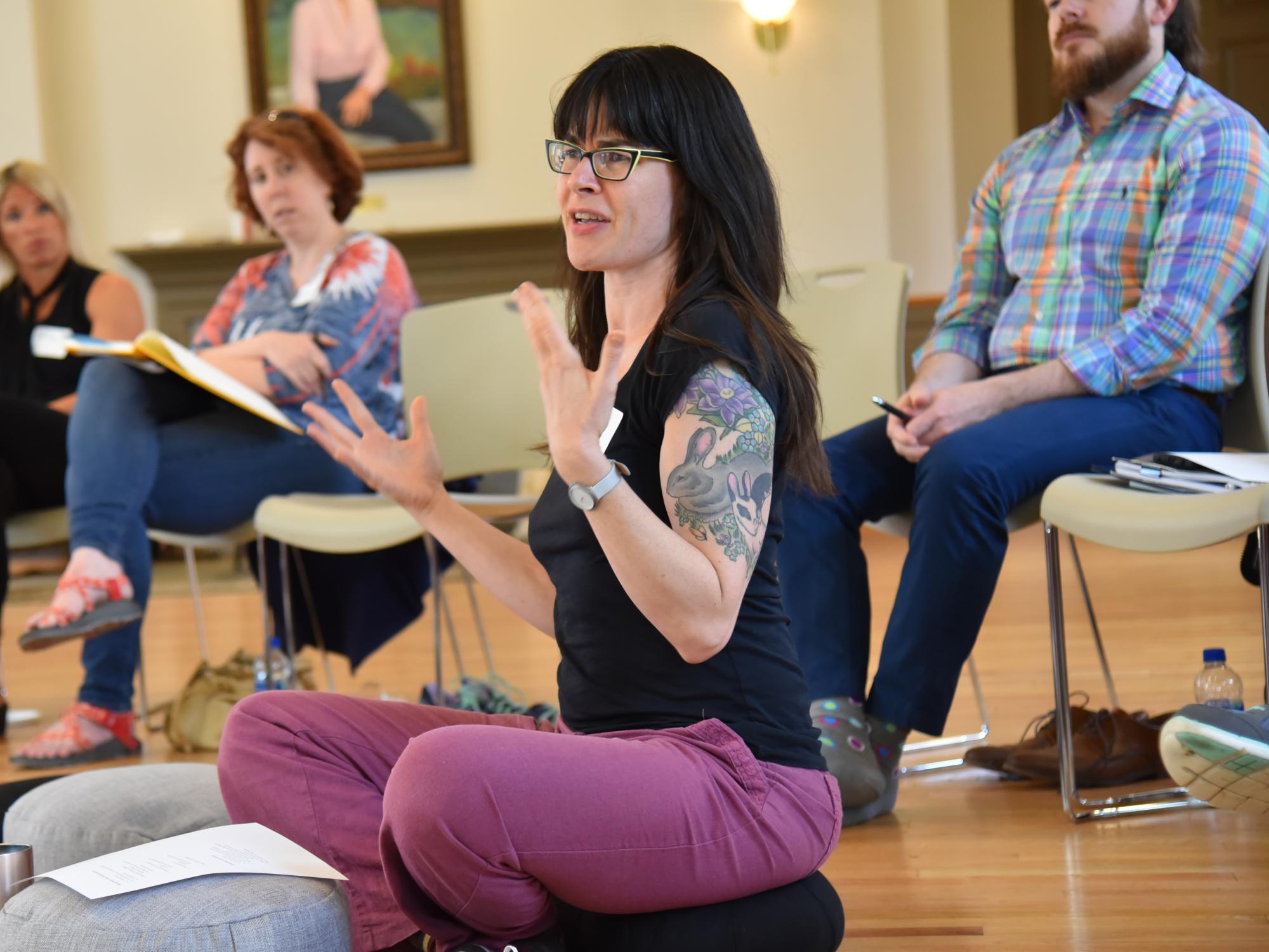 woman seated on yoga cushion