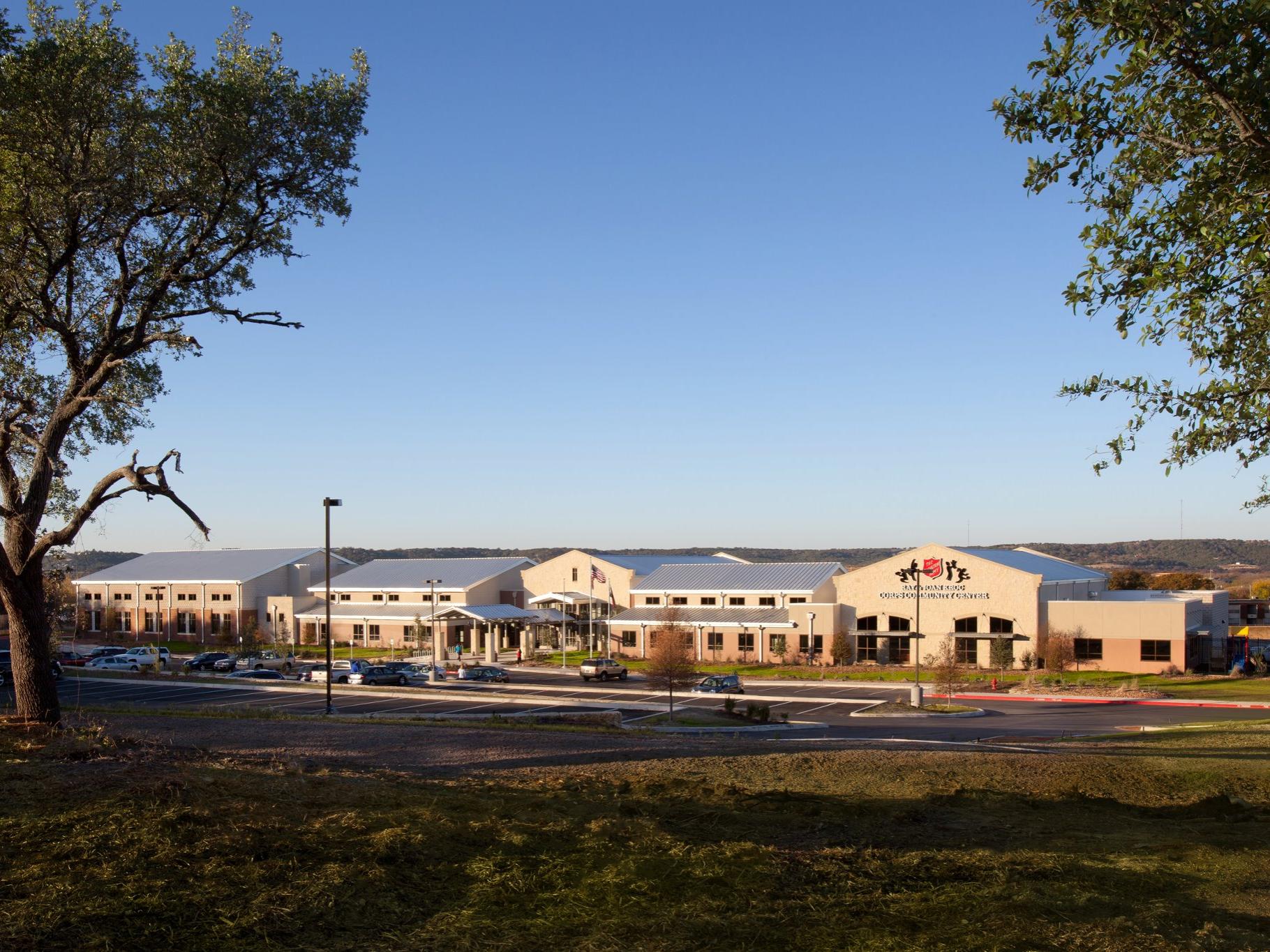 Large community center in a field with blue sky