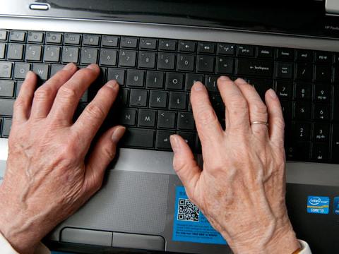 hands typing on keyboard