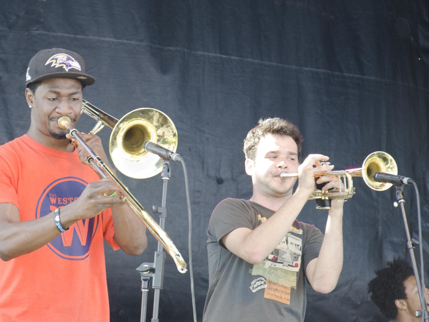 The horn section of Kids These Days performs