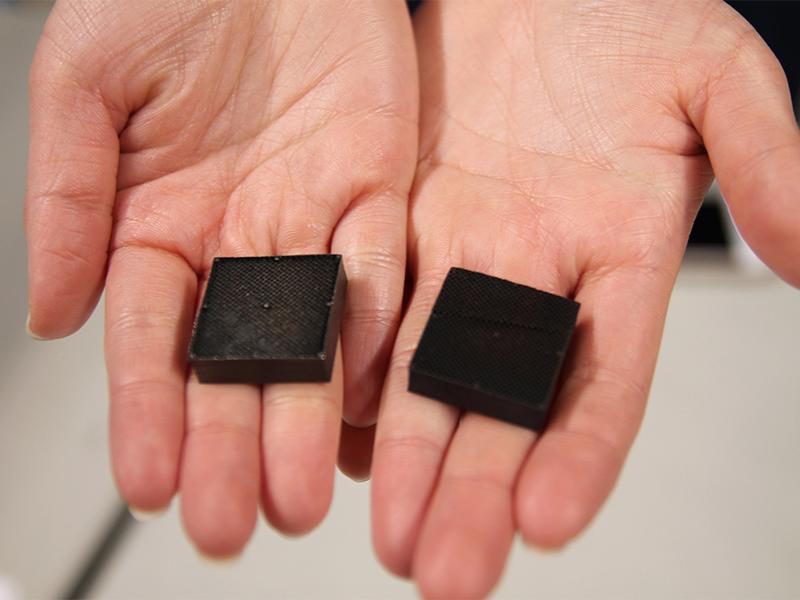 A student shows off a method for chemically removing bracing required for some 3D metal printing. The project was sponsored by Penn State’s Center for Innovative Materials Processing (3D-CIMP) lab.