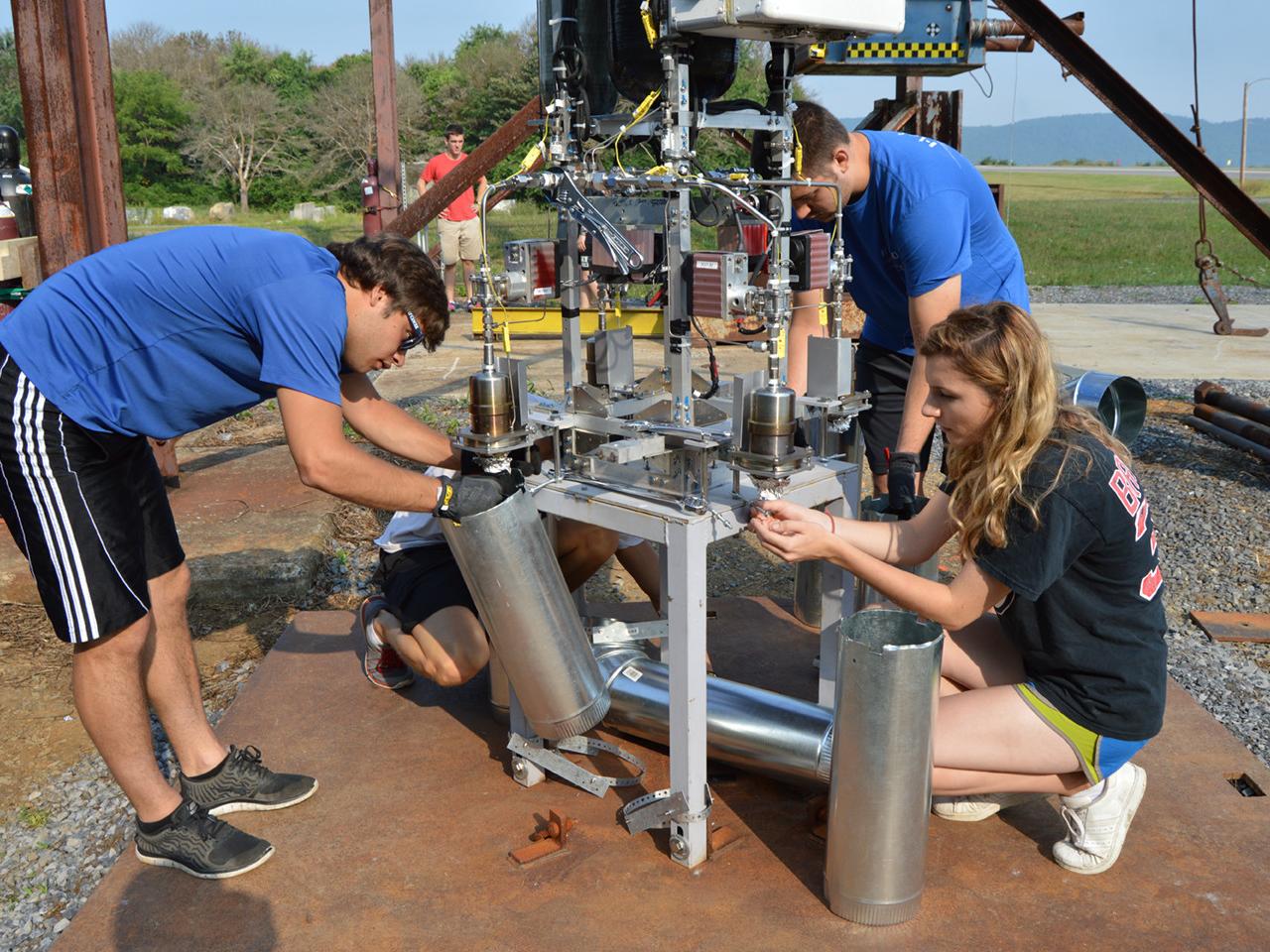 Students affix testing prototype to table prior to testing