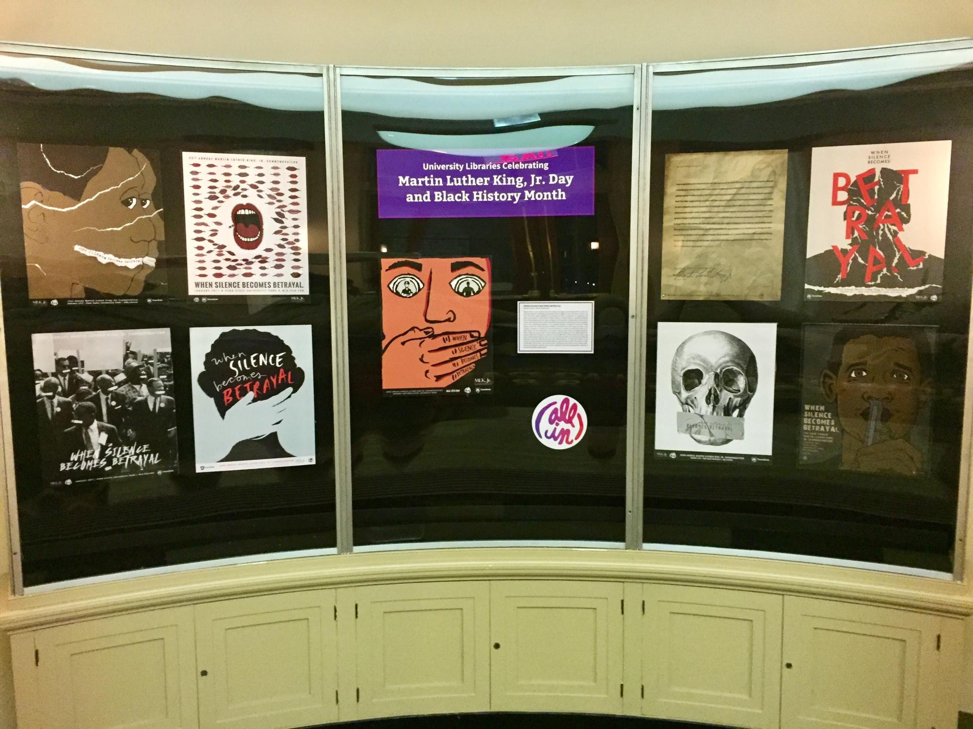 photo of display case showing 9 students' graphic design posters representing Martin Luther King Day at Penn State