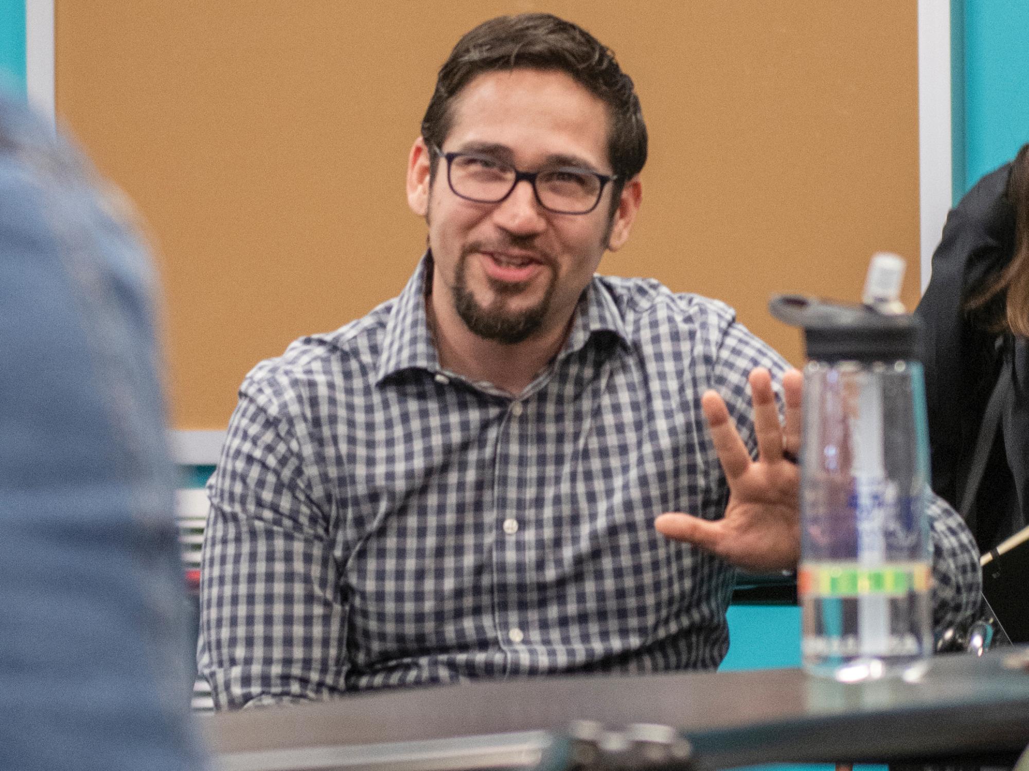 Efraín Marimón gesturing in conversation.