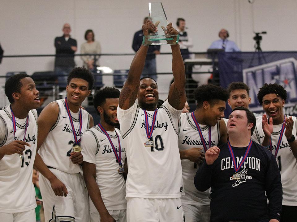 basketball players lifting trophy