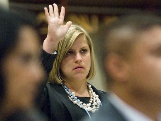 Meredith Mills raises a hand in class