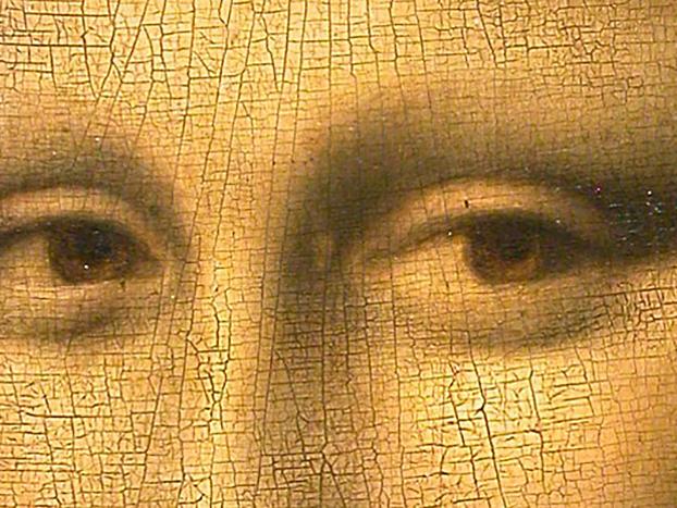 A closeup of the Mona Lisa shows unique patterns created by the canvas and the paint shifting over time.