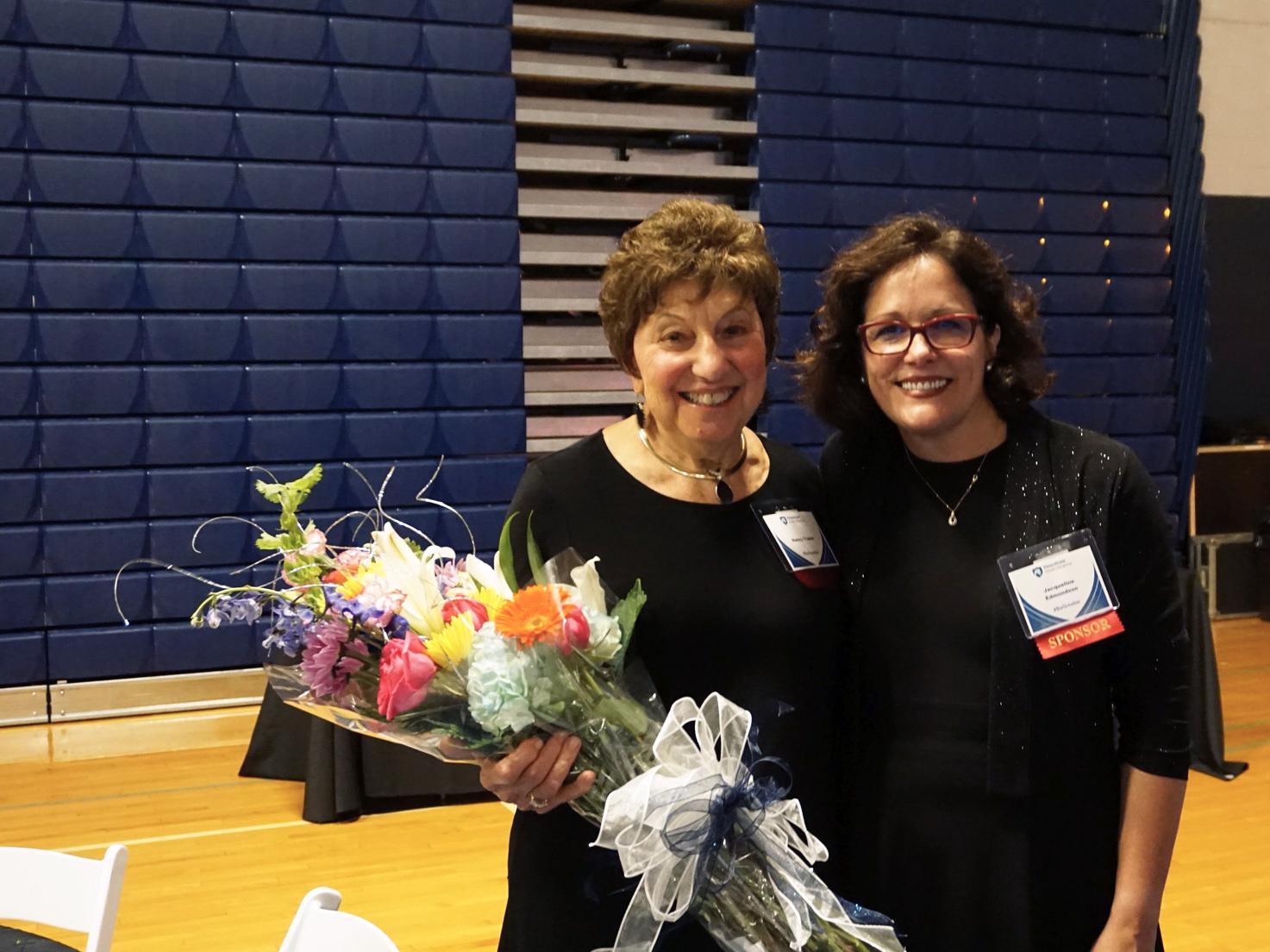 Nancy Traina holding bouquet of flowers standing next to Chancellor Dr. Edmondson 