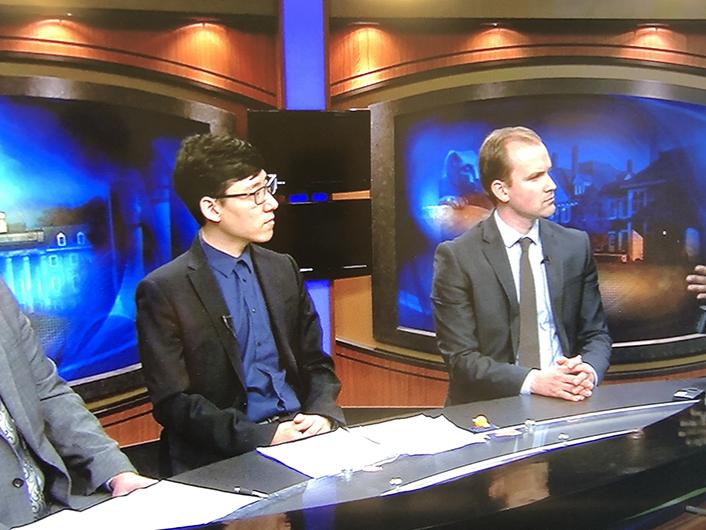 Students participate in a simulated prime-time news panel