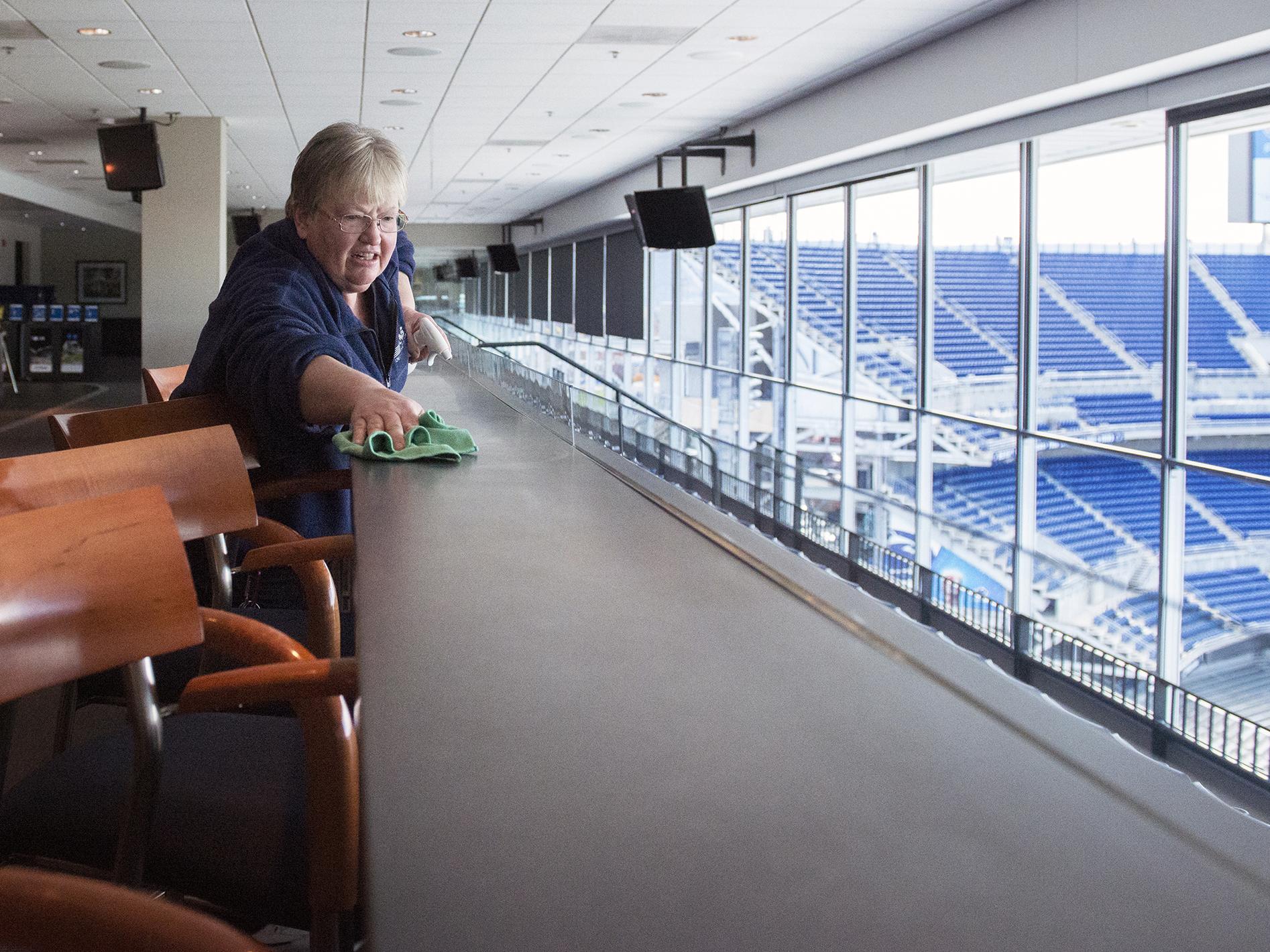 Renee Wilson dusting President's suite in Beaver Stadium