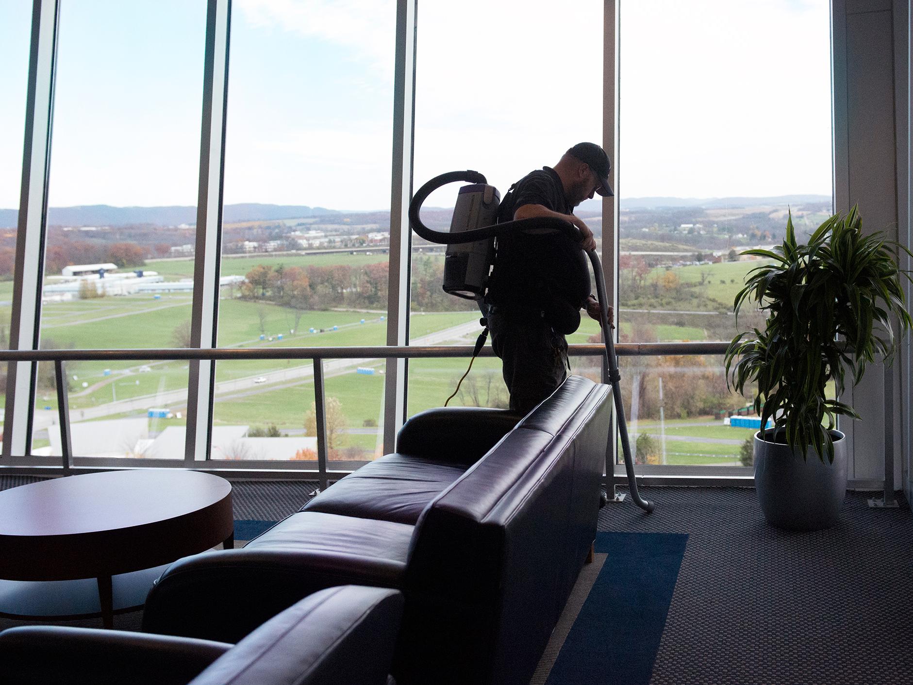 A man vacuuming a suite at Beaver Stadium