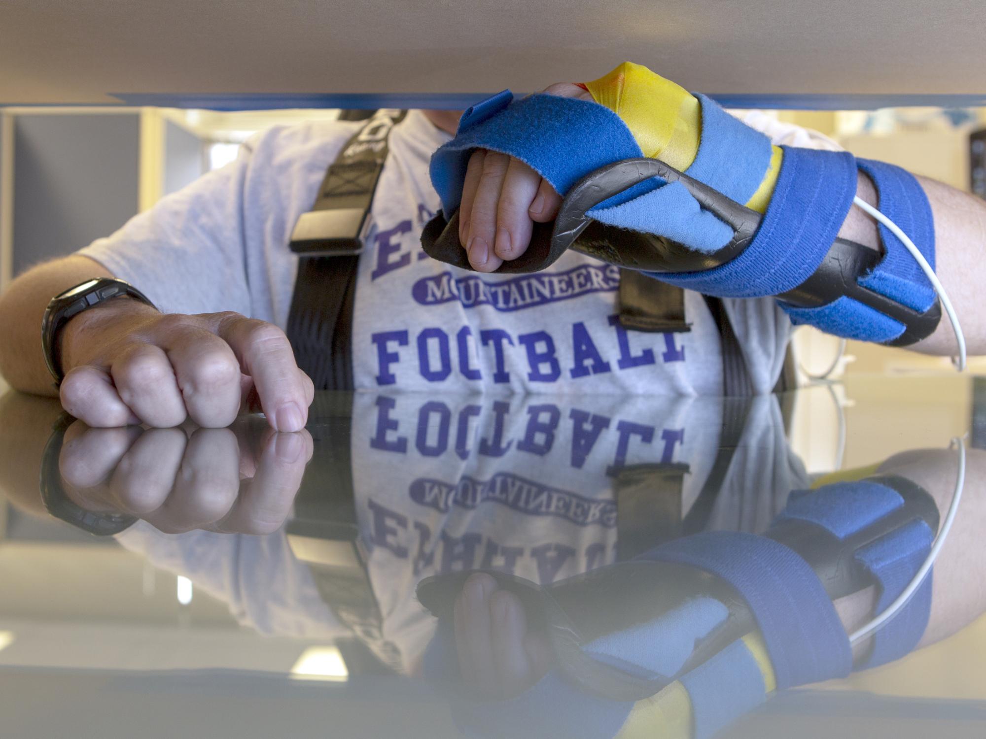 Volunteer's arm attached to sensors in the Kinereach