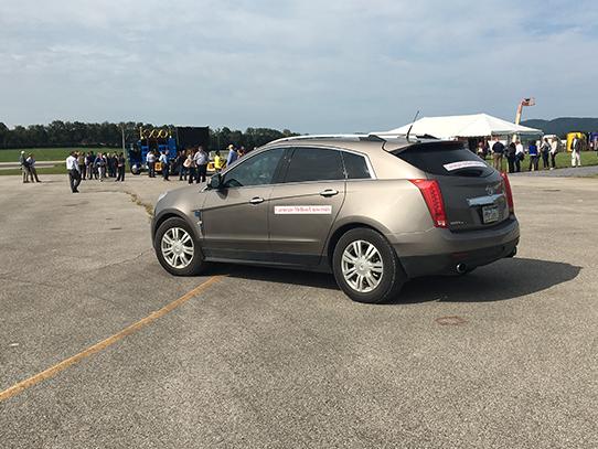 Gold Cadillac SRX SUV parked on pavement