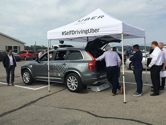 Summit attendees view Uber's self-driving Volvo XC90 display