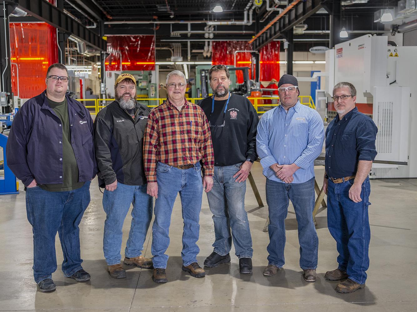 Six faculty standing together