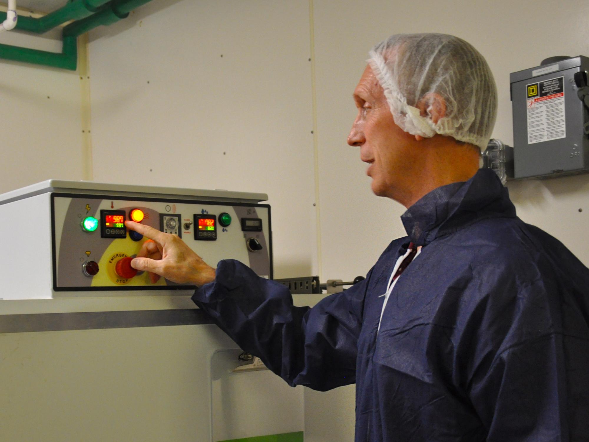 Mike Hulet makes adjustments to the incubator at the Poultry Education Research Center