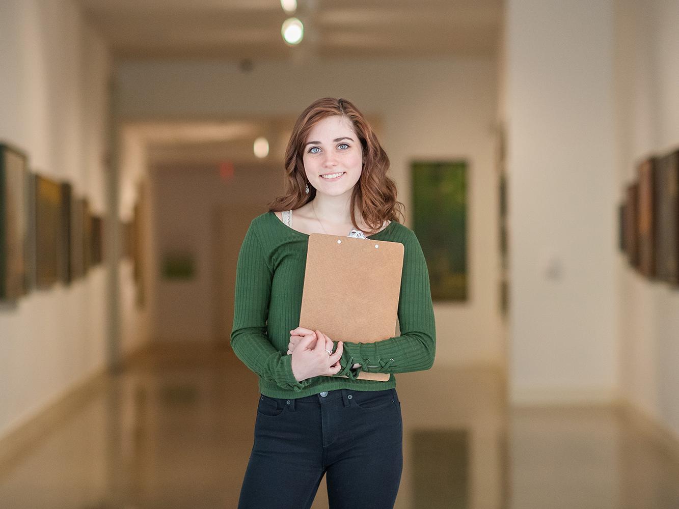 Olivia Coghe, pictured here, graduated in May with degrees in both arts administration and digital media, arts and technology.