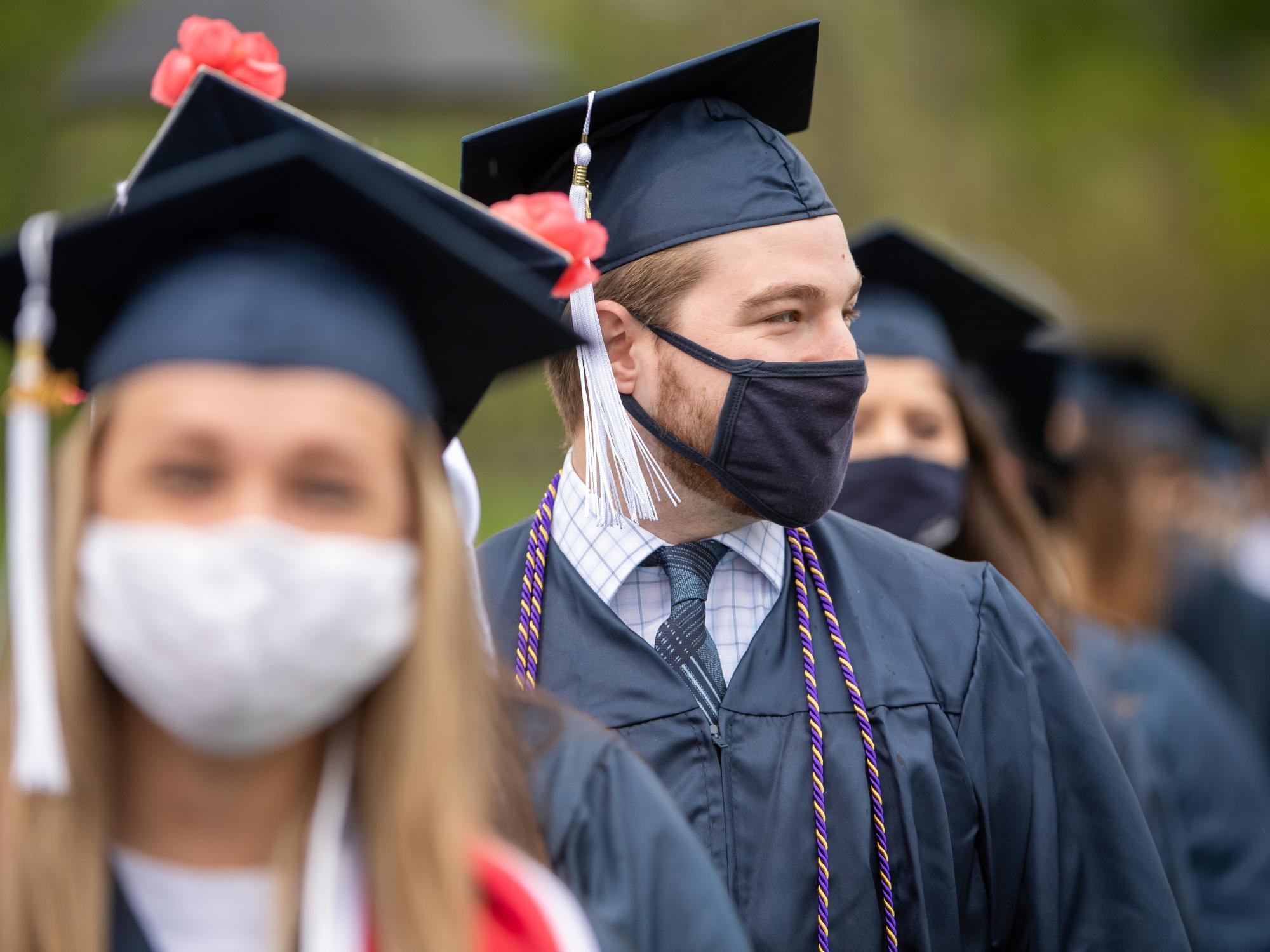Penn State Behrend graduates enter the college's soccer stadium for a commencement program on May 8.