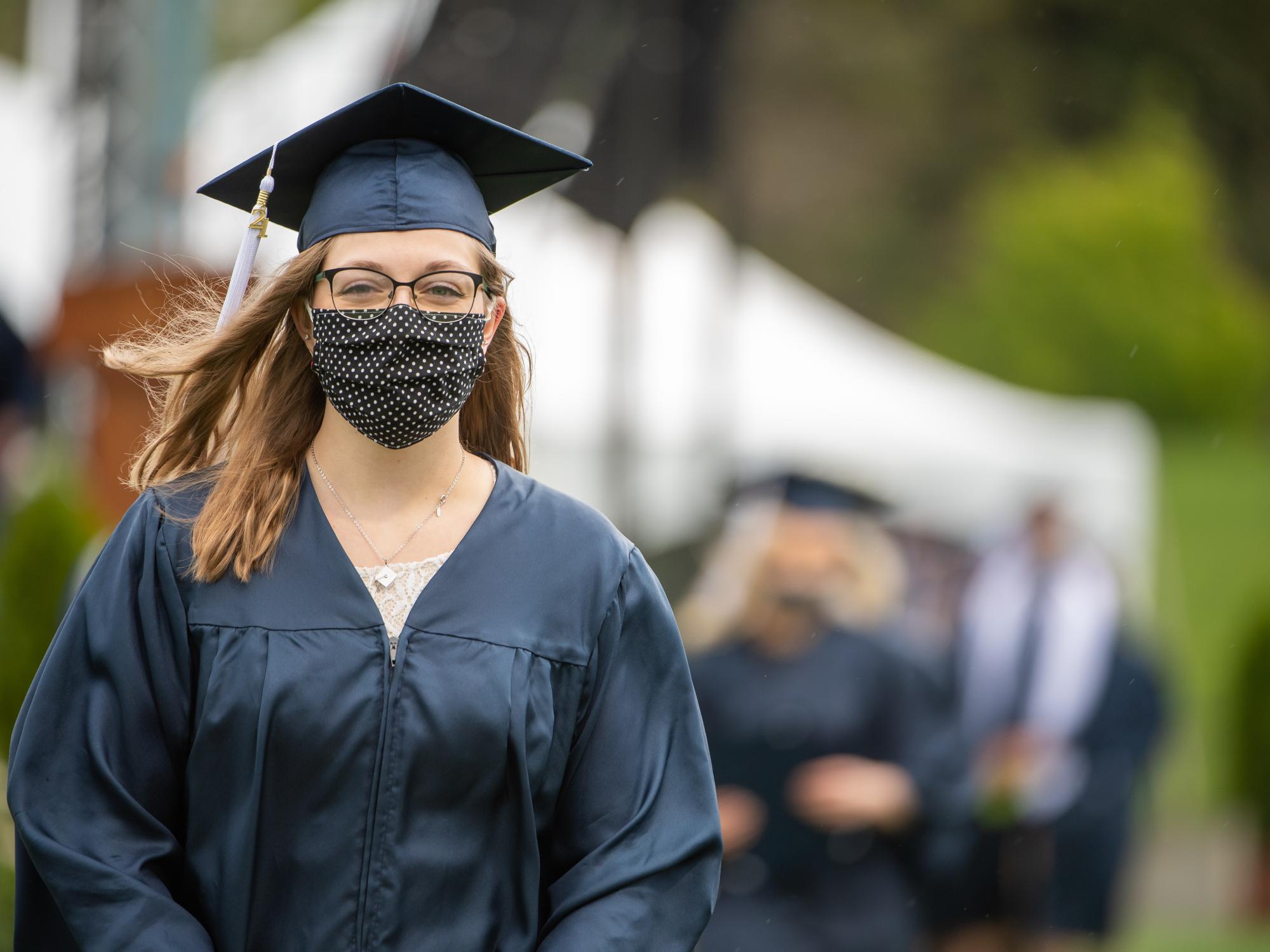 A Penn State Behrend graduate returns to her seat after receiving her diploma.