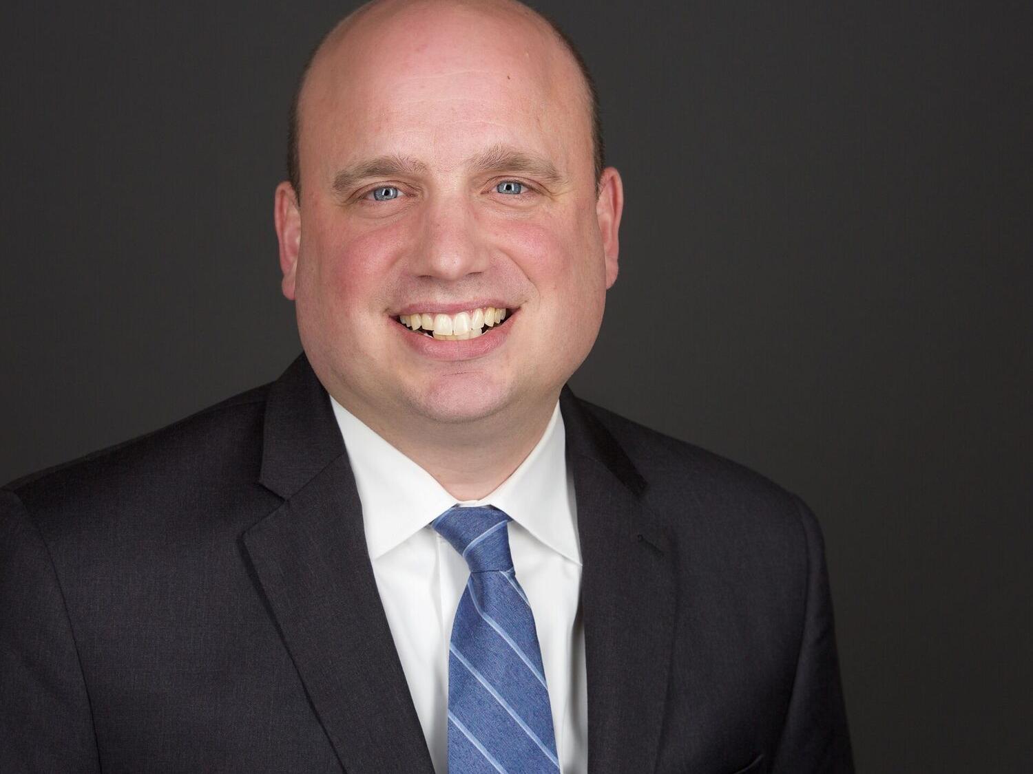 headshot of man in suit