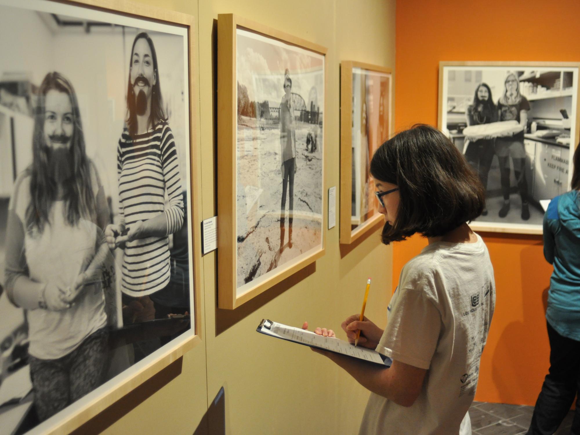 A student visits The Bearded Lady Project exhibit in the Earth and Mineral Sciences Museum & Art Gallery 