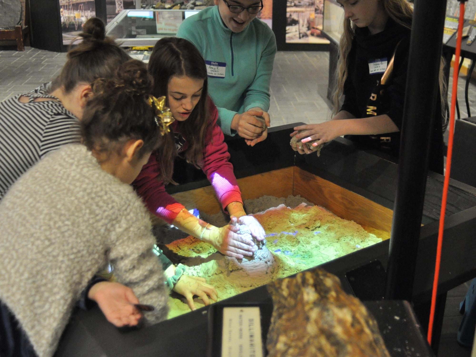 Students interact with an exhibit in the Earth and Mineral Sciences Museum & Art Gallery 
