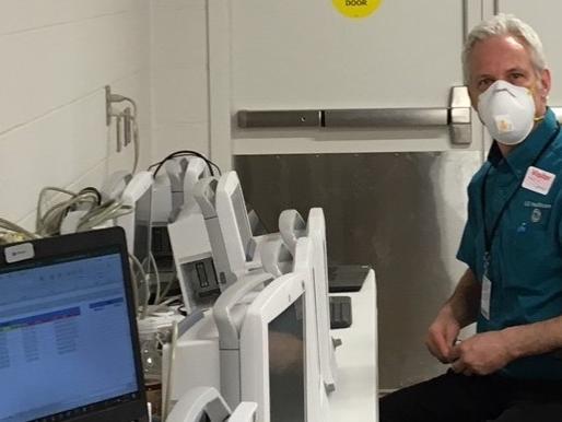 Man sitting next to medical equipment