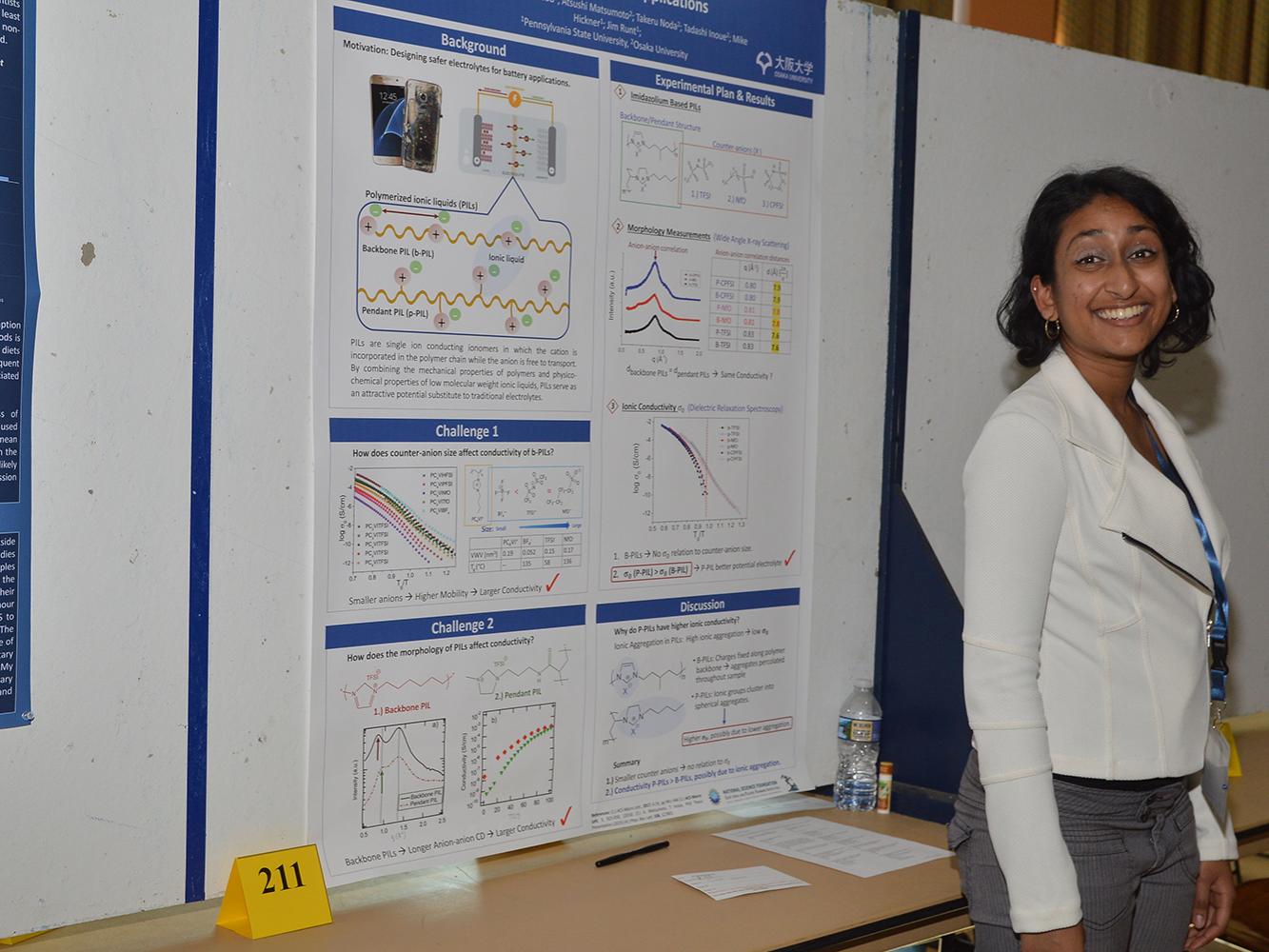 Preeya Kuray, materials science and engineering graduate student, stands next to her research poster