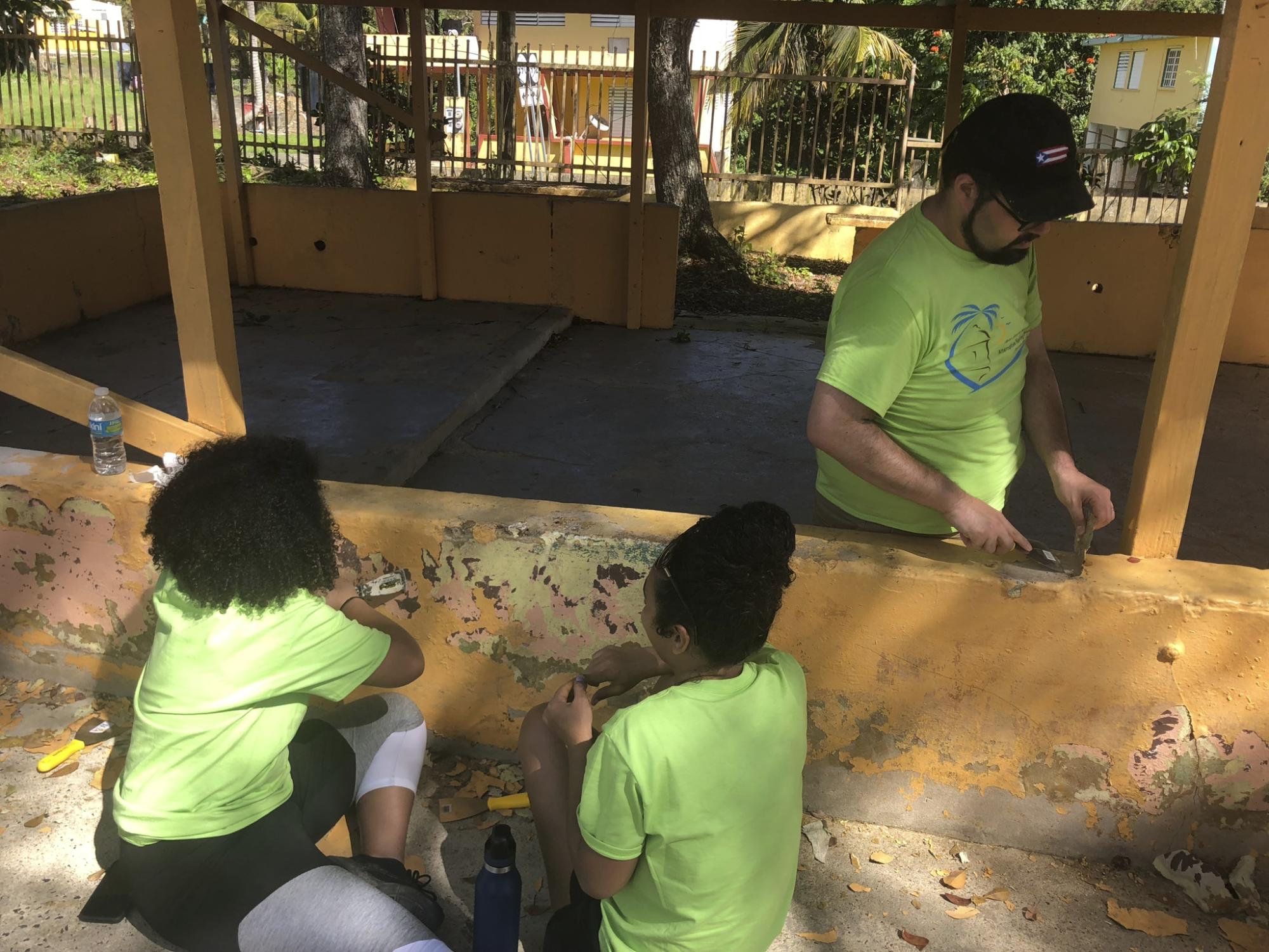 three students painting
