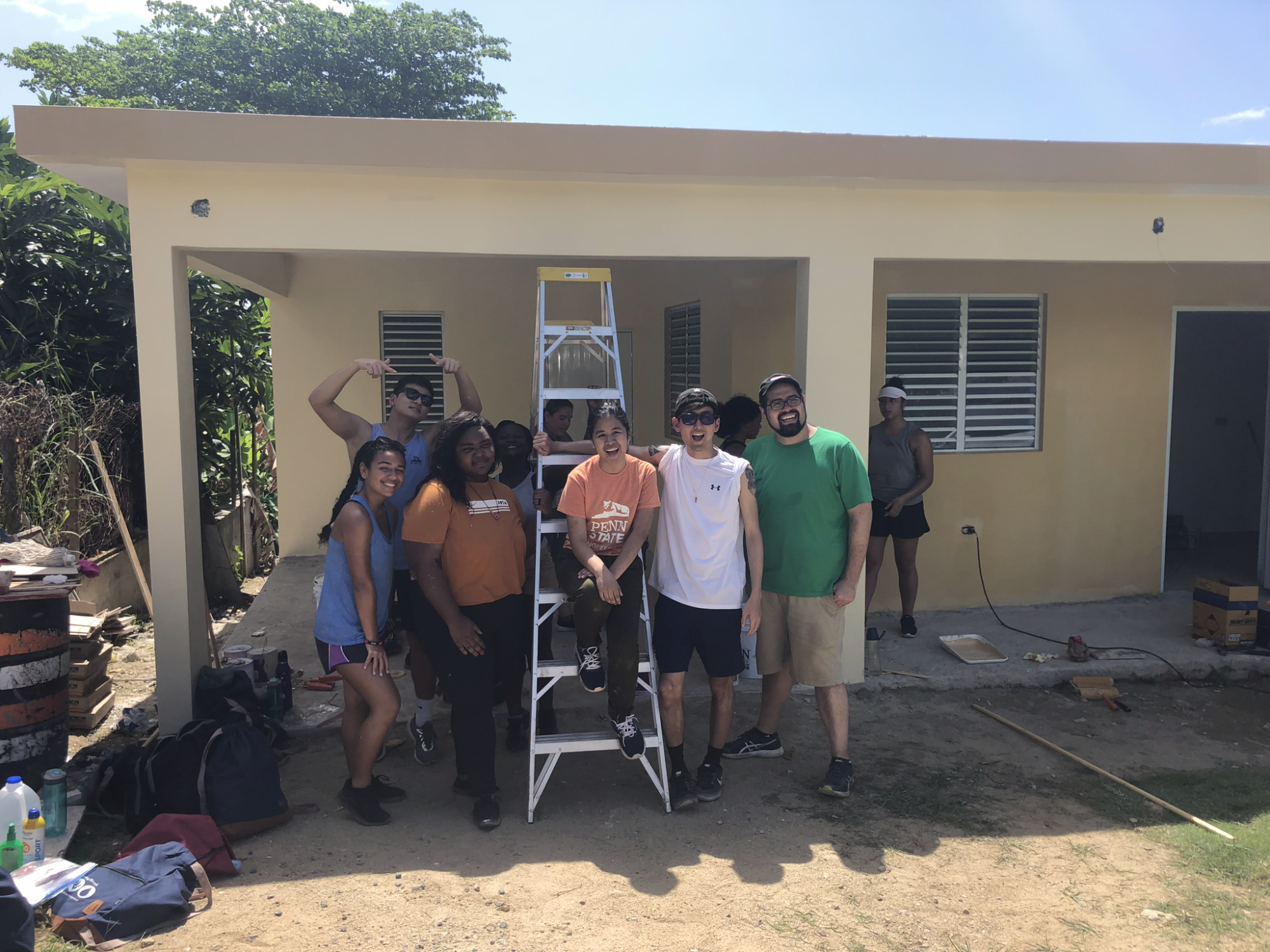 students in front of house