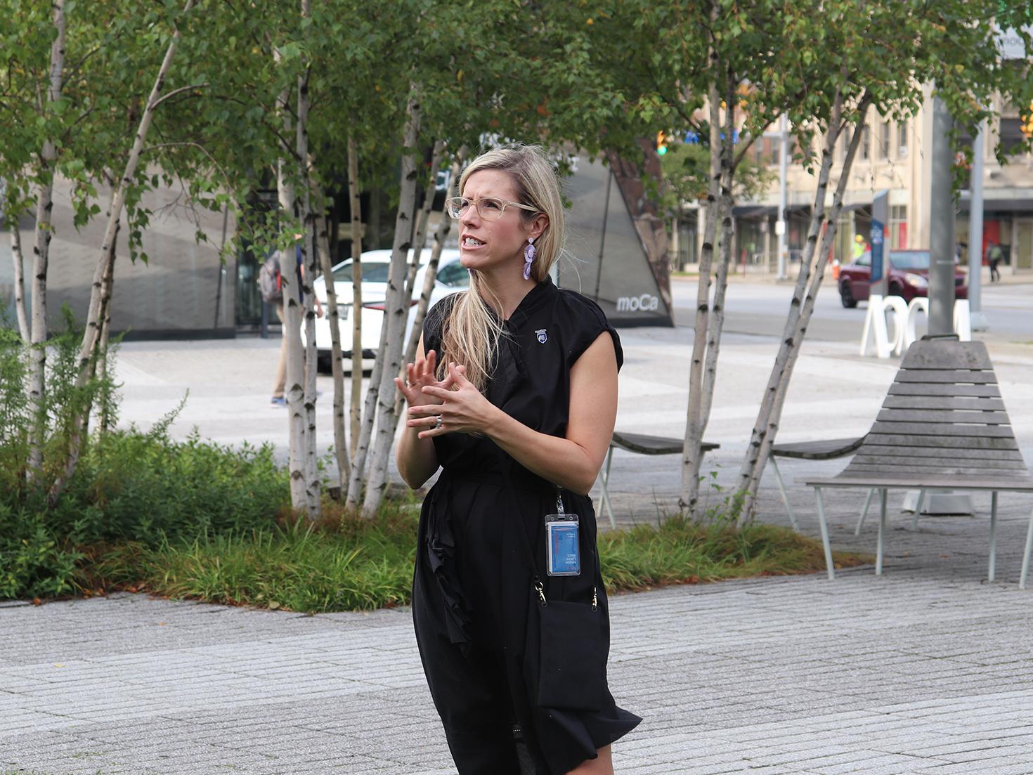 Megan Lykins-Reich addresses students outside the Museum of Contemporary Art in Cleveland.