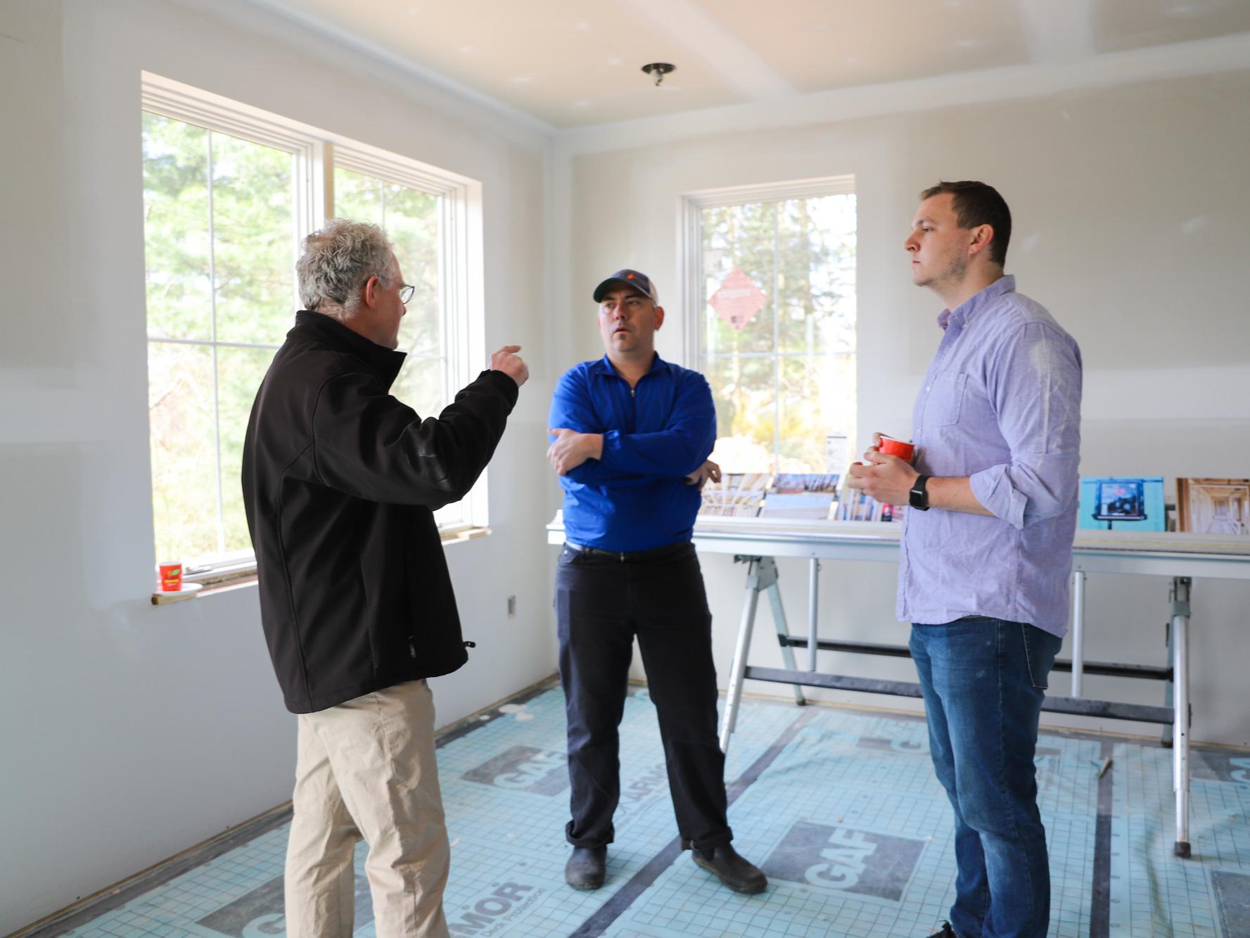Chris Hazel, Scott Wing, and Peter Buckland discuss the GreenBuild home during the Blue White Alumni Weekend Tour