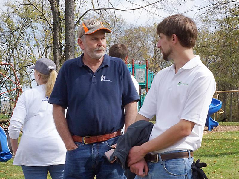 Dalton Fantechi, right, (senior, geosciences) talks with an employee at Range to learn more about the unique geological features at Cross Creek County Park. 