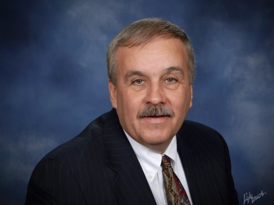 head shot of man in suit