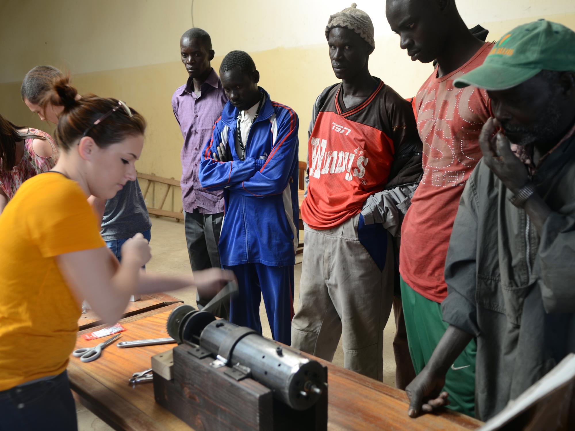 Alyssa Joslin demonstrates a seed press to the farmers