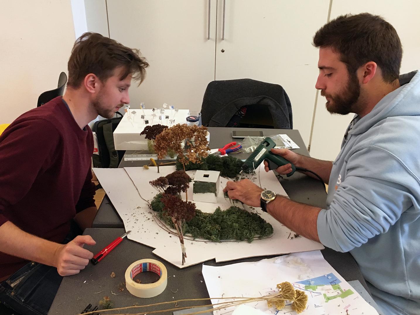 Penn State student Hawkin Slusarski, right, and a teammate assemble their model.