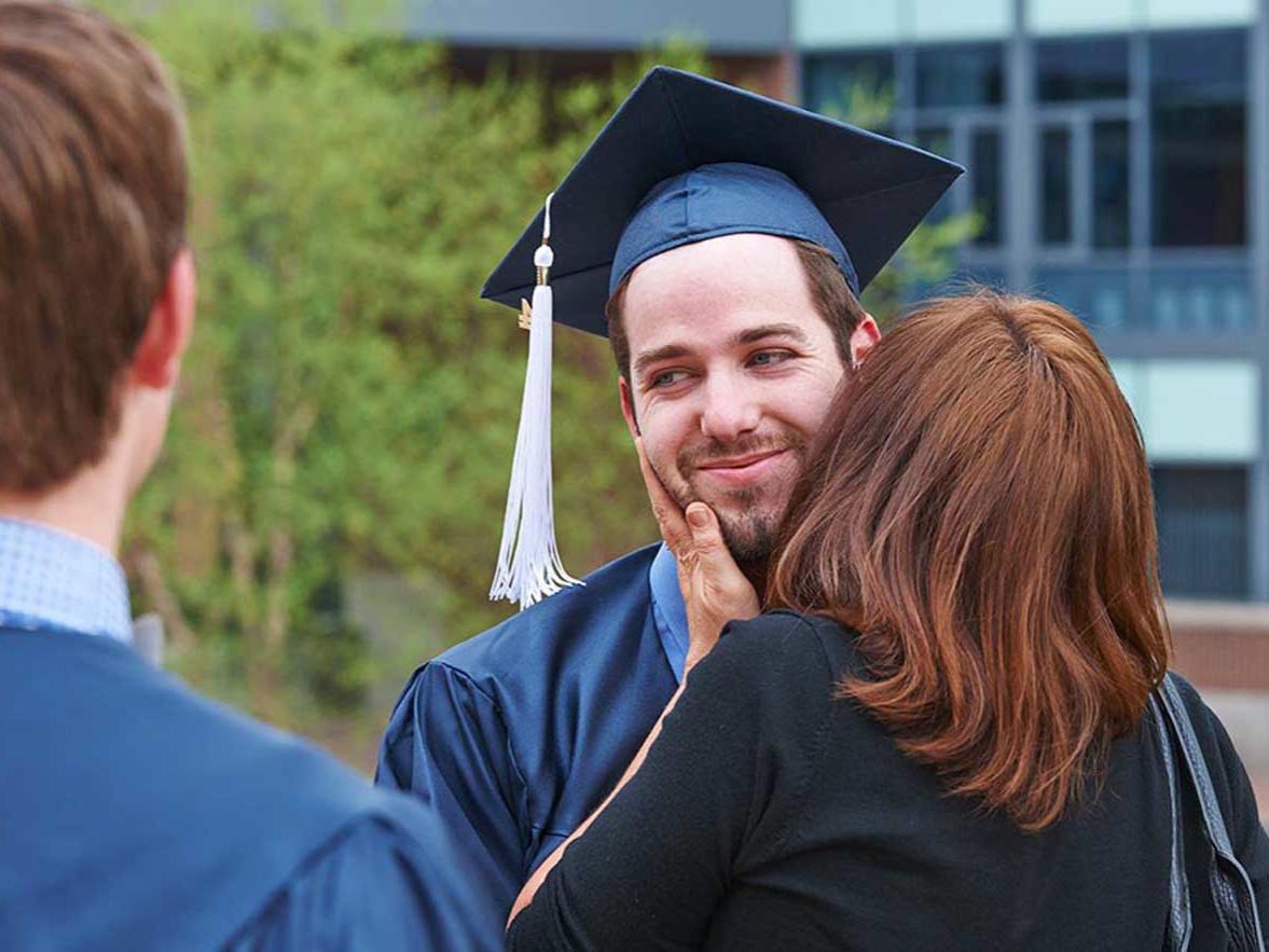 Schreyer graduating senior is greeted by a family member