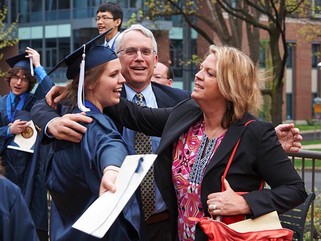 A graduating Schreyer Scholar is greeted by family members