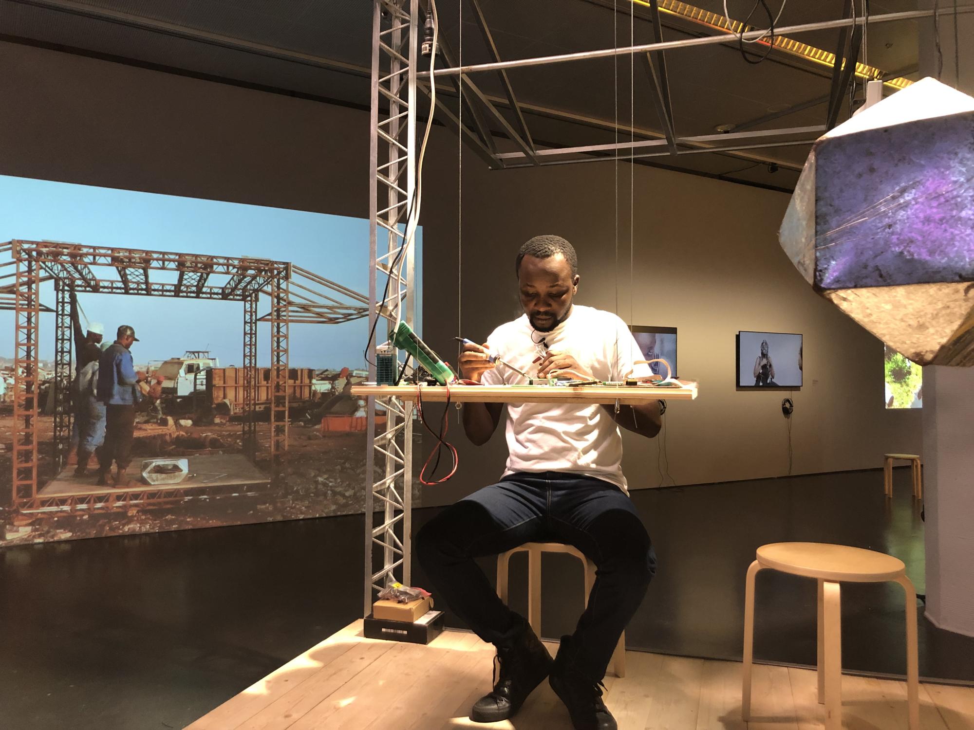 An engineering lab manager olders an air quality and environmental sensing unit during a technical demonstration at the ZKM.