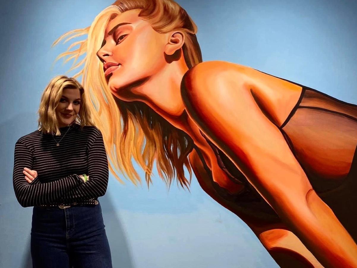 Sarah Jameson posing in front of painting