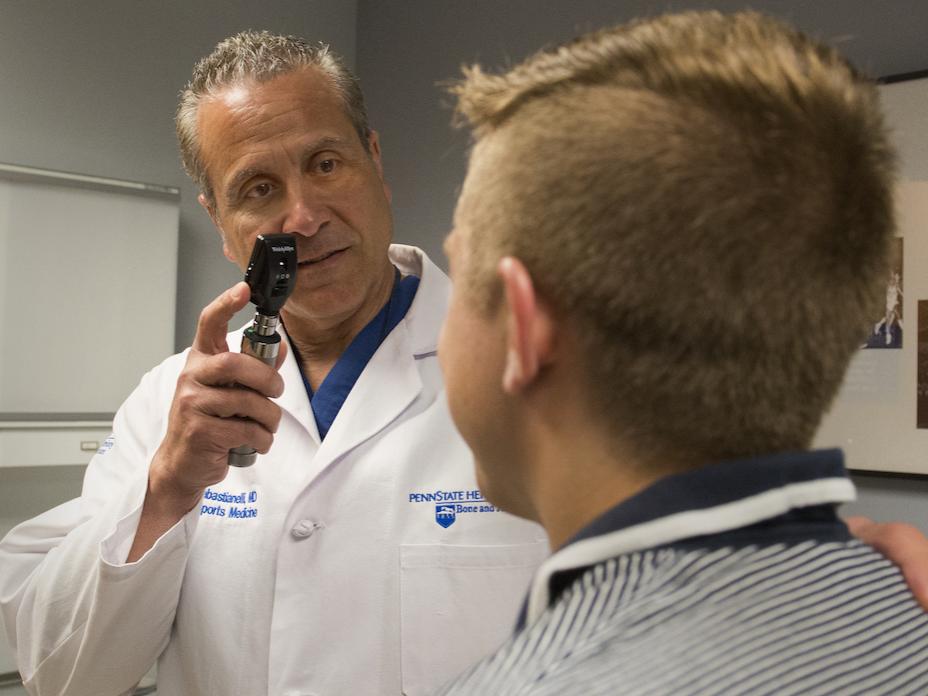 Dr. Wayne Sebastianelli examines a patient