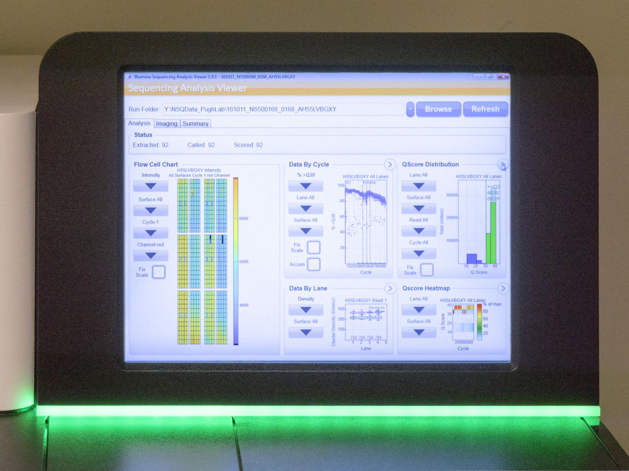 The lit screen of a gene sequencer displaying data