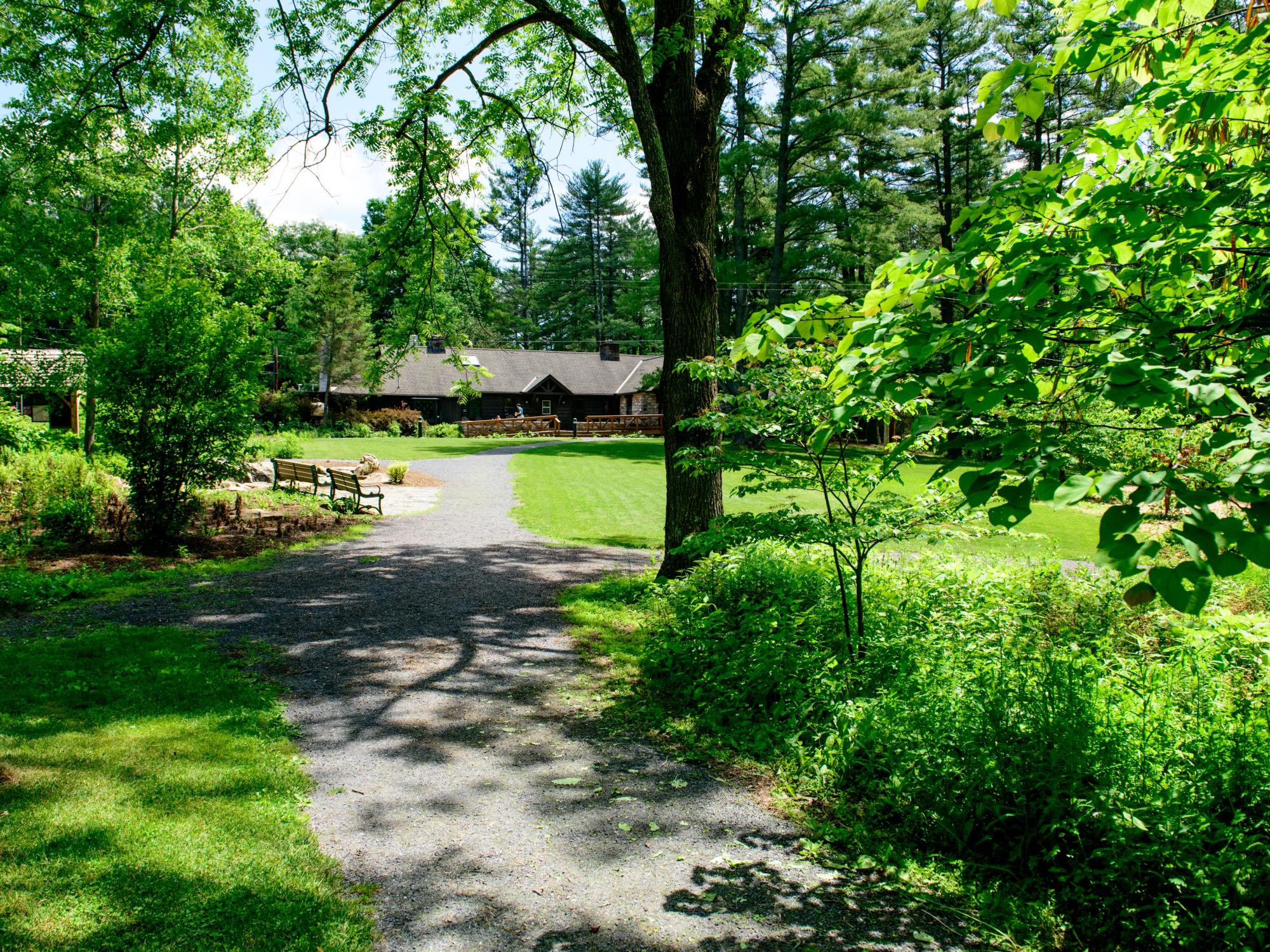 A wide outdoor shot of the Shaver's Creek Environmental Center on a bright summer day.