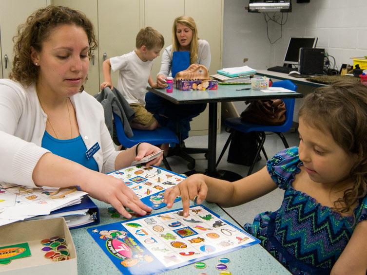 Miranda Padilla helping a student with speech therapy.