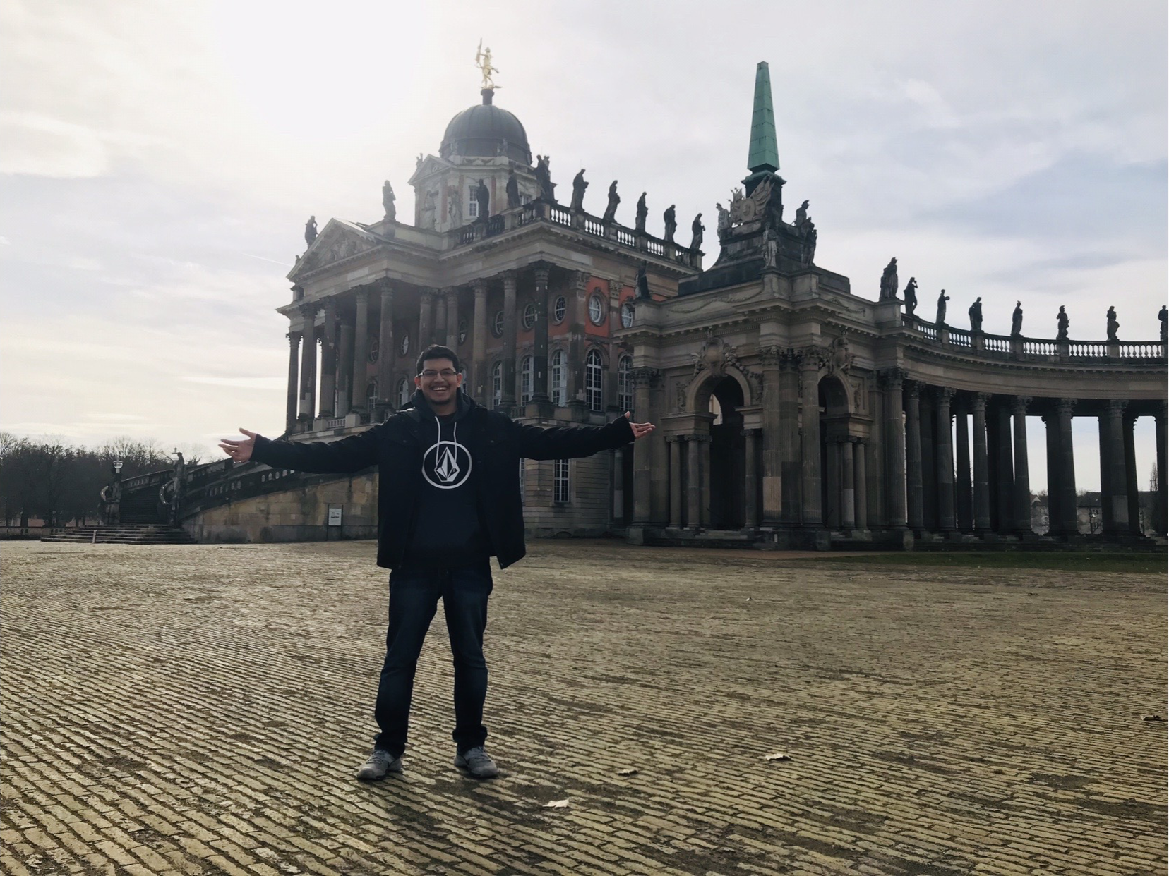 student in front of a German building
