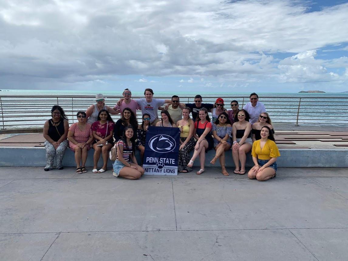 group of students and faculty in front of an ocean in Puerto Rico