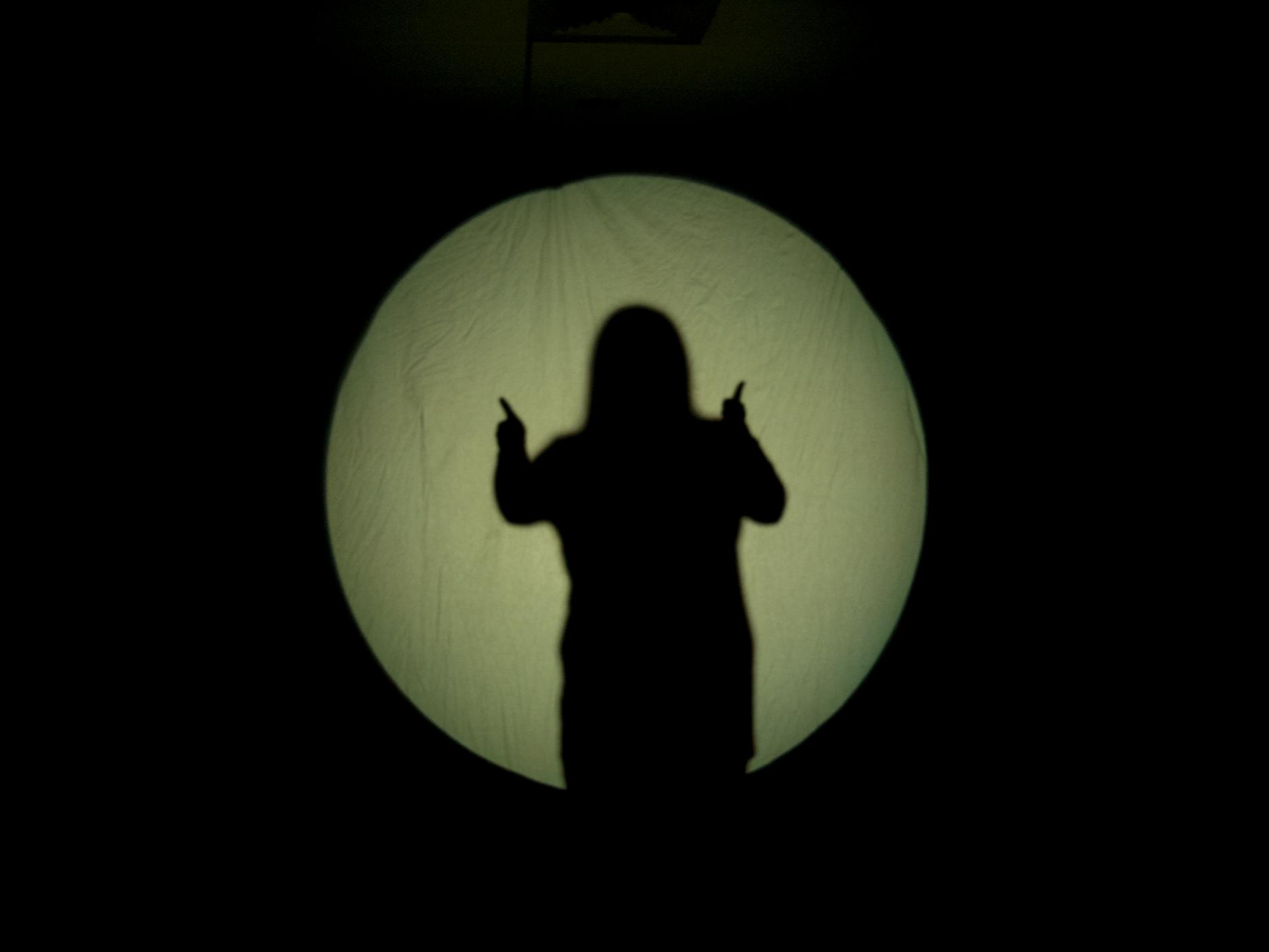 The shadow of student giving thumbs up
