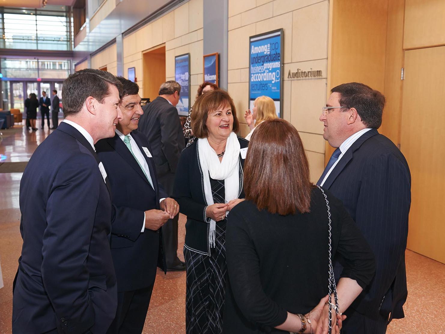Smeal's Director of Development Todd Sloan talks with the Strickler family and the Sredni family