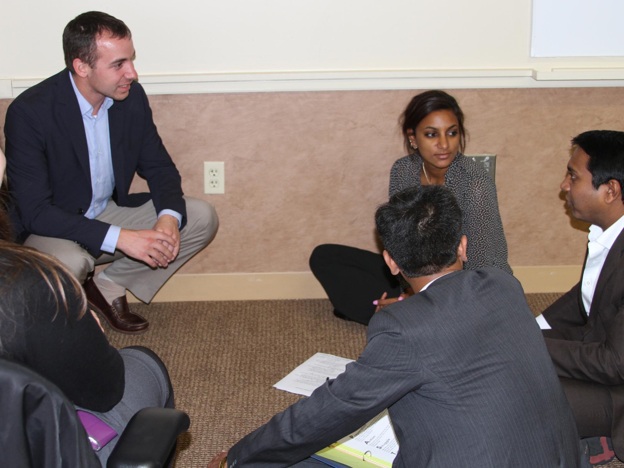An MBA student tells his story to a group.