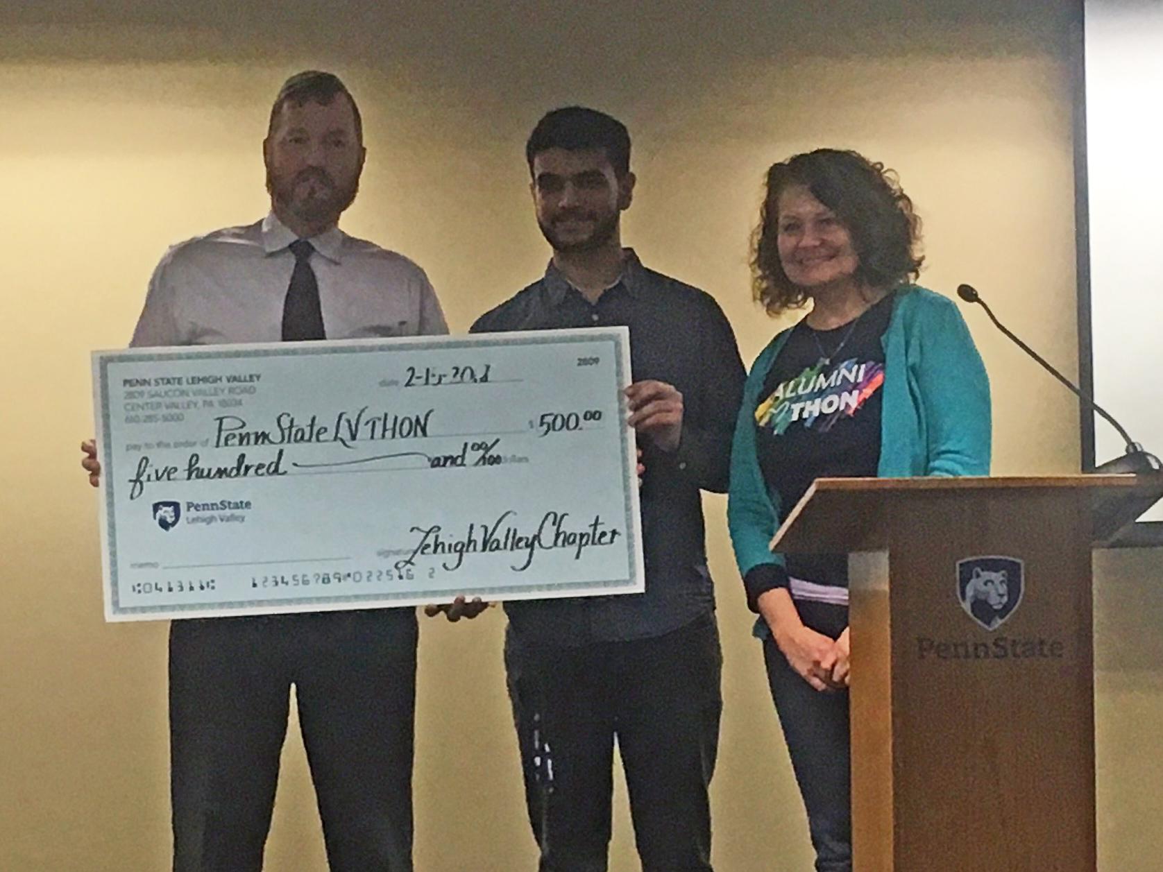 man presents big check